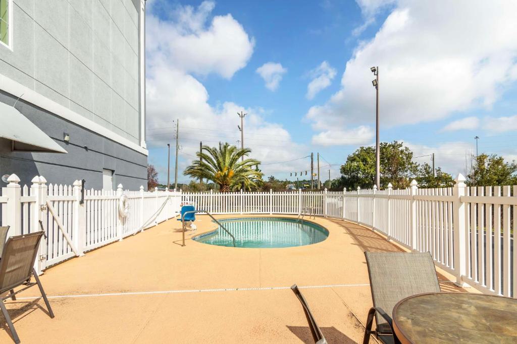 a patio with a pool and a white fence at Best Western Plus Brunswick Inn & Suites in Brunswick
