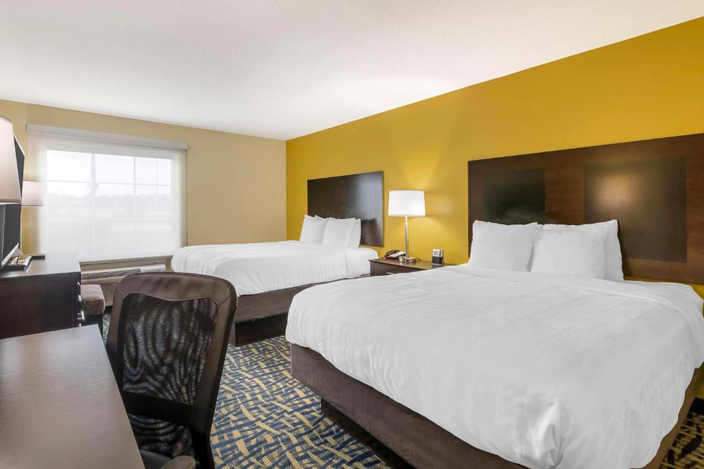 a hotel room with two beds and a desk at Best Western Plus Brunswick Inn & Suites in Brunswick
