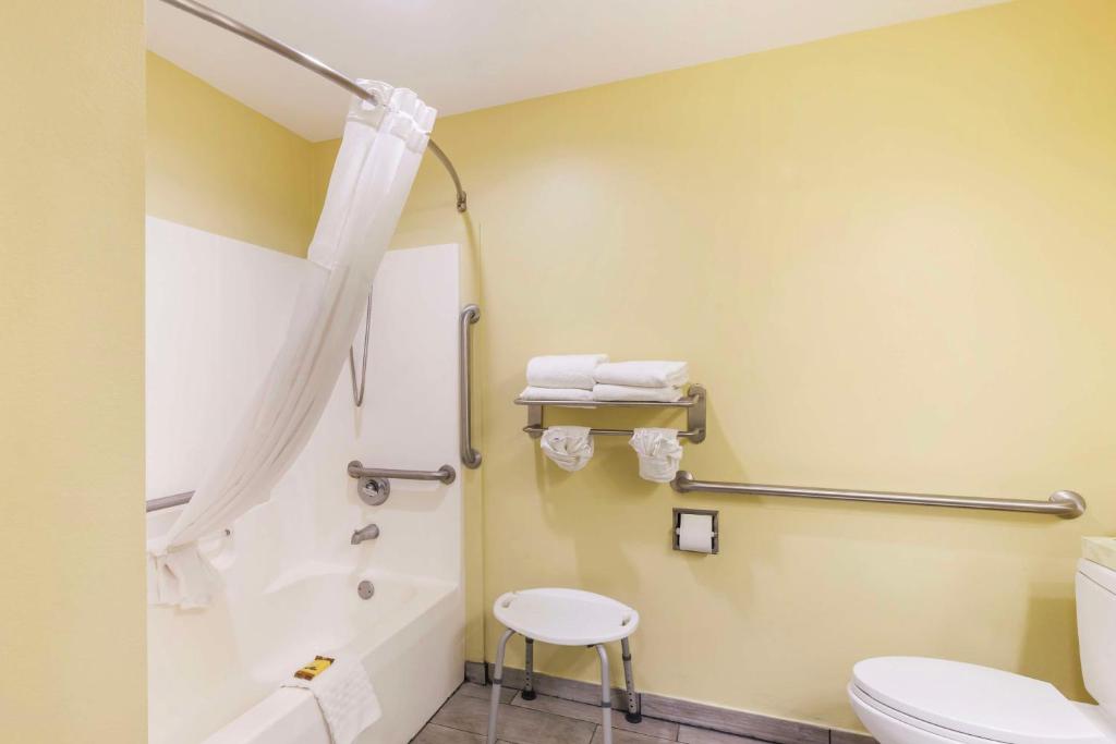 a bathroom with a toilet and a tub and a sink at Best Western Plus Brunswick Inn & Suites in Brunswick