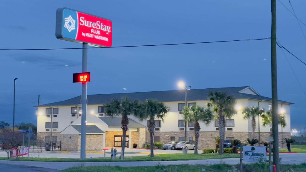 a building with a street sign in front of it at SureStay Plus by Best Western St. James Donaldsonville in Donaldsonville