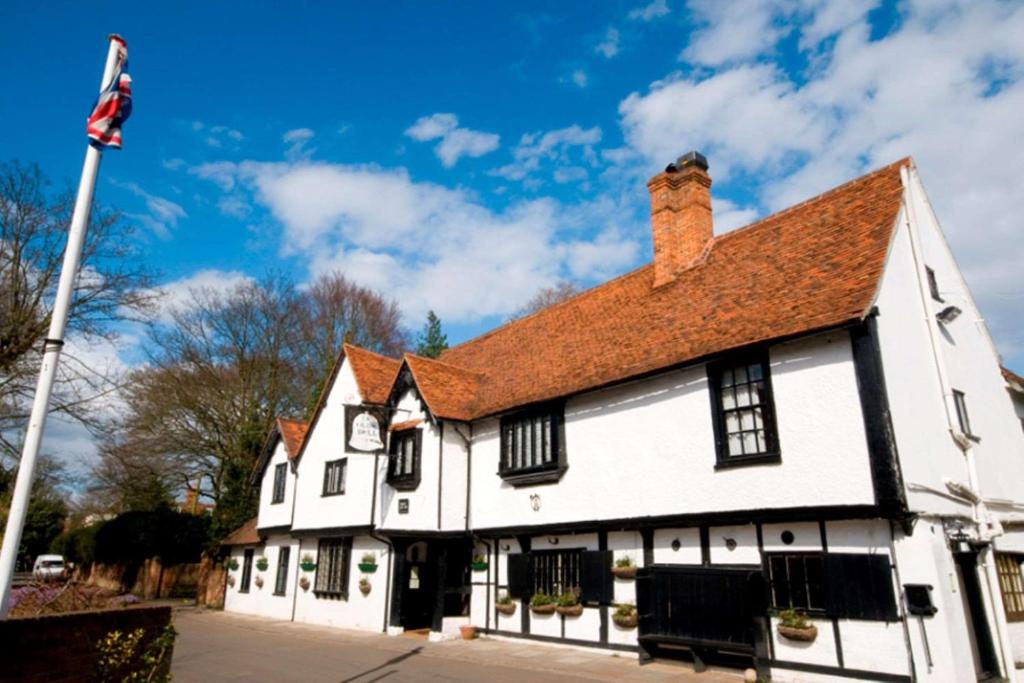 a white building with a red roof at The Olde Bell, BW Signature Collection in Marlow