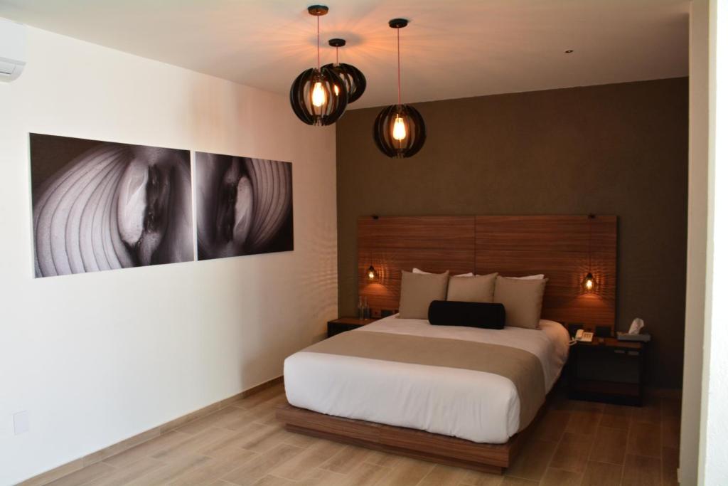 Postel nebo postele na pokoji v ubytování Ilo Rojo Hotel Boutique