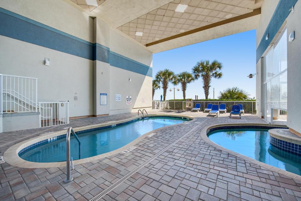 a large swimming pool in a building with a pool at Stylish Oceanview Getaway Modern 1BR at Carolinian Resort" in Myrtle Beach