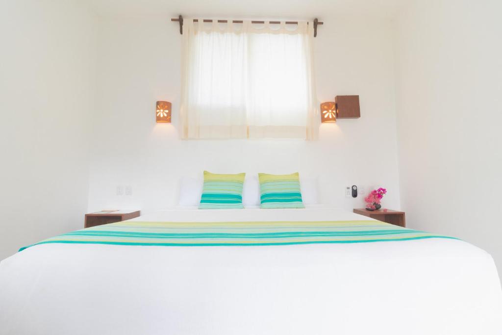 Postel nebo postele na pokoji v ubytování Maison Bacalar
