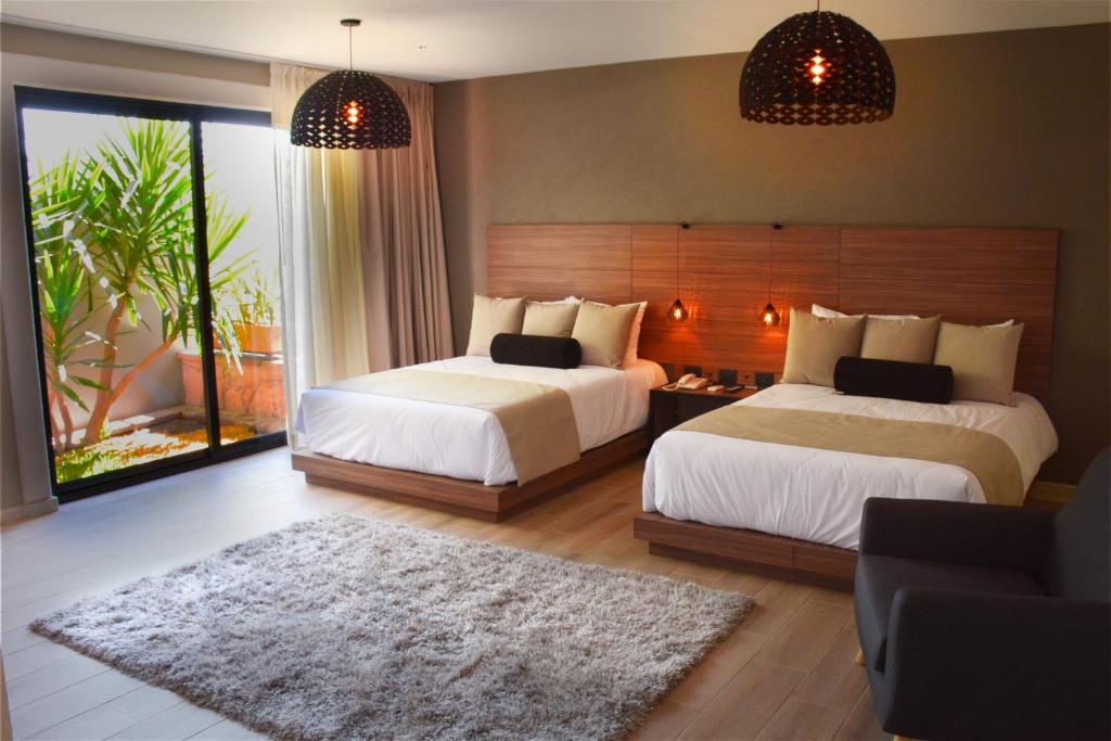 Postel nebo postele na pokoji v ubytování Ilo Rojo Hotel Boutique