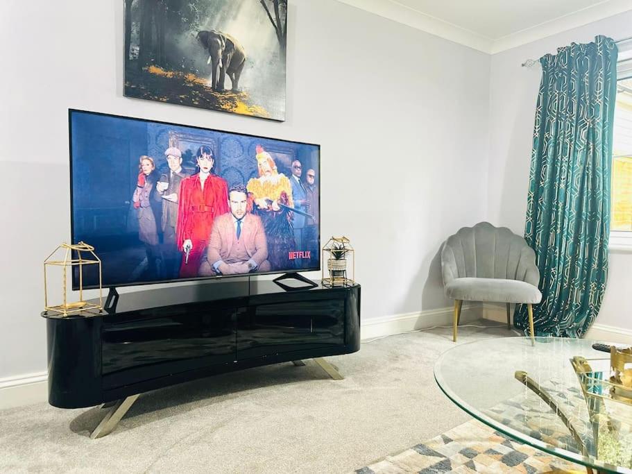 a living room with a large flat screen tv at The Esplanade Lodge-Free Parking in Strood