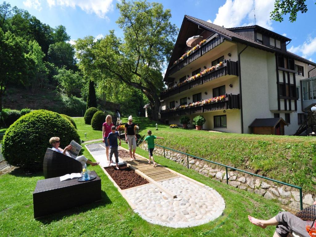 a group of people standing in a yard in front of a building at Landhotel Pfrondorfer Mühle in Nagold