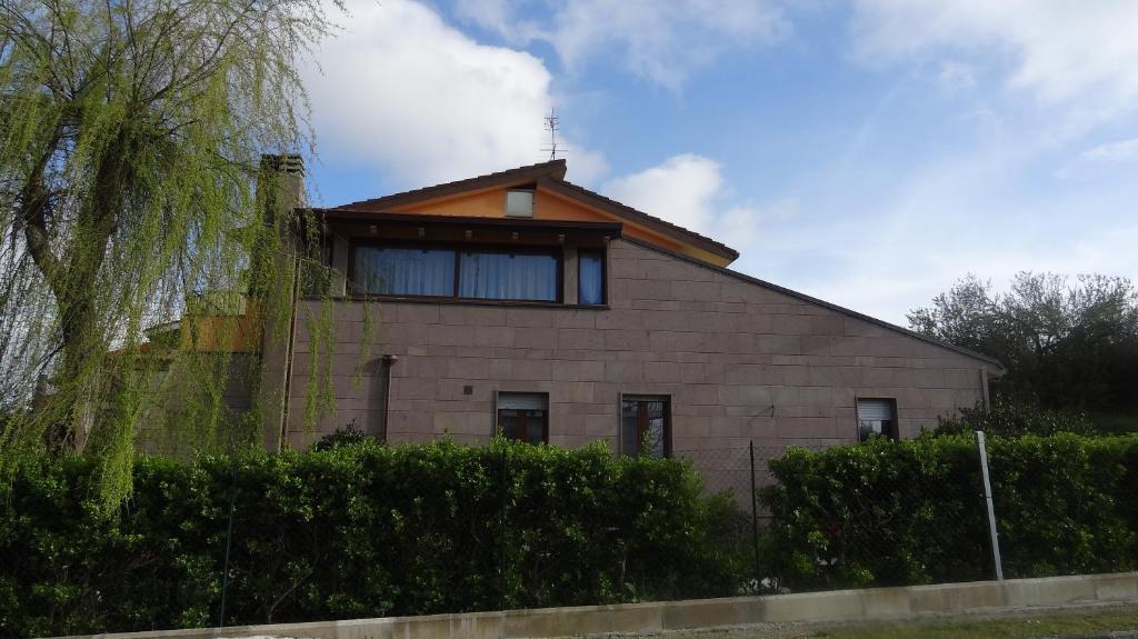 a building with a tree in front of it at Sa Mariposa in Ittiri