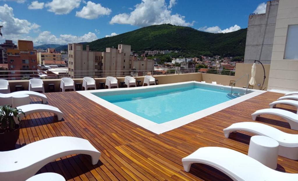 a swimming pool on the roof of a building at Hotel Alvarado Suites in Salta