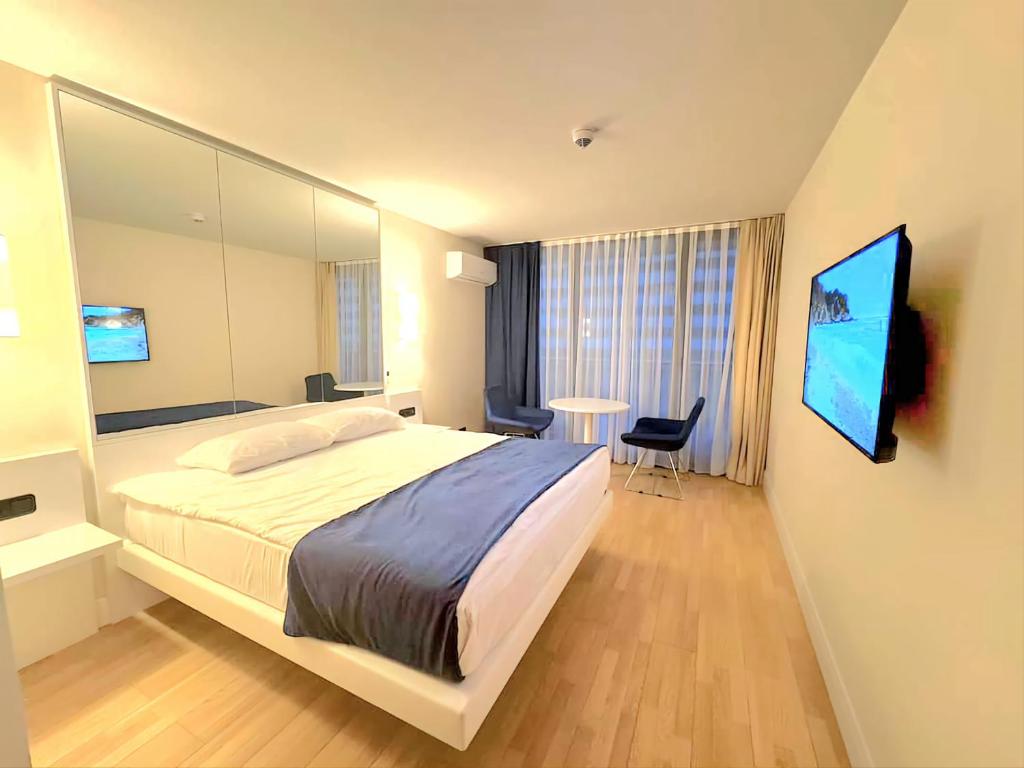 a bedroom with a large bed and a table at ORBI CITY batumi in Batumi