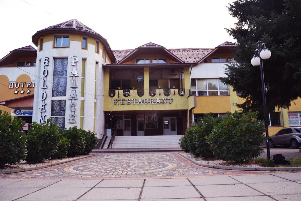 a building with a sign on the front of it at Golden Palace in Dubove