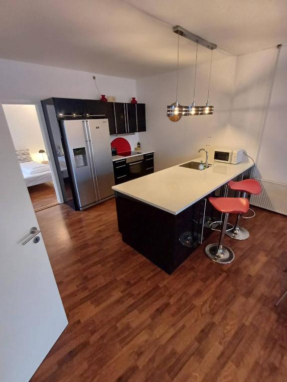 a kitchen with a island in the middle of a room at Stylish Apartment On Pedestrian Street Randers in Randers