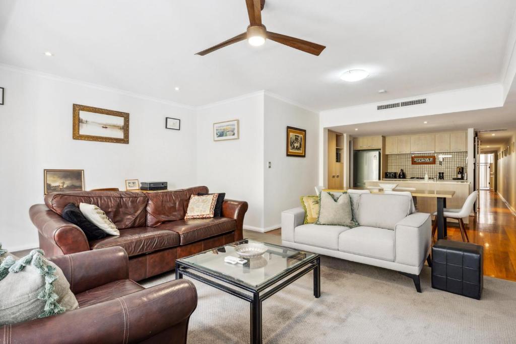 a living room with a couch and a table at Central Fremantle 2 Bedroom - Walk to Shops and Beach in Fremantle