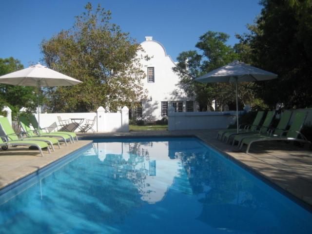 The swimming pool at or close to Jacaranda Wine And Guestfarm