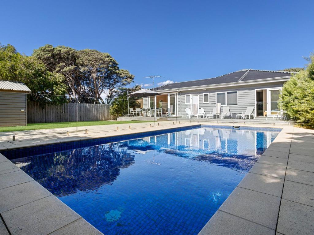a swimming pool in front of a house at Bluetopia in Rye