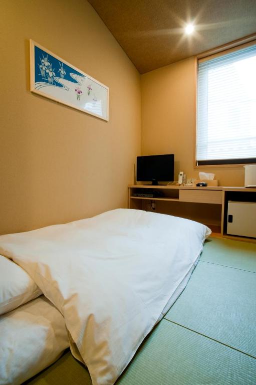 Postel nebo postele na pokoji v ubytování Ochanomizu Hotel Shoryukan