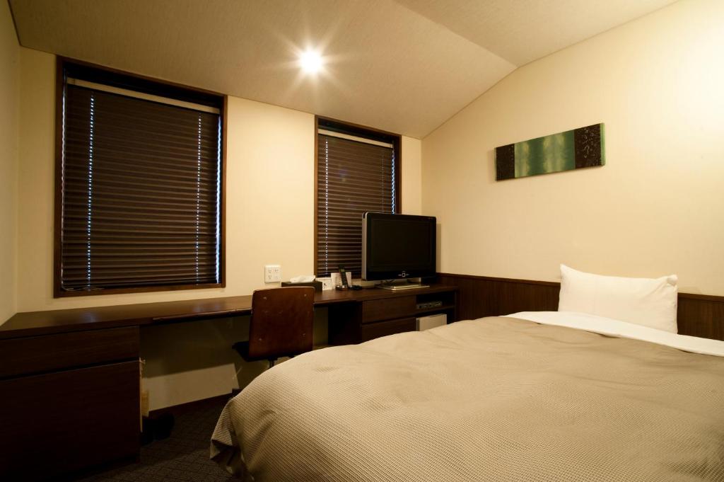 Postel nebo postele na pokoji v ubytování Ochanomizu Hotel Shoryukan