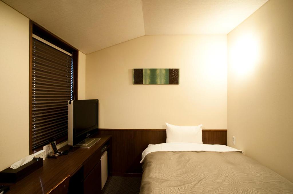 Postel nebo postele na pokoji v ubytování Ochanomizu Hotel Shoryukan
