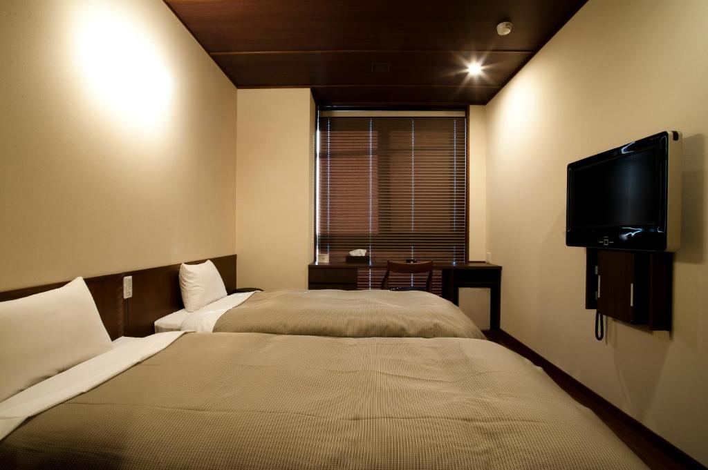 Postel nebo postele na pokoji v ubytování Ochanomizu Hotel Shoryukan