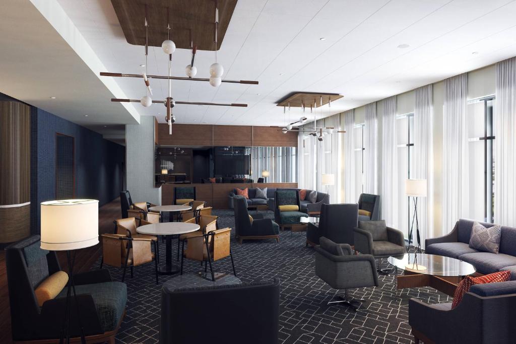 a lobby with couches and chairs and tables at Courtyard by Marriott Regina Downtown in Regina