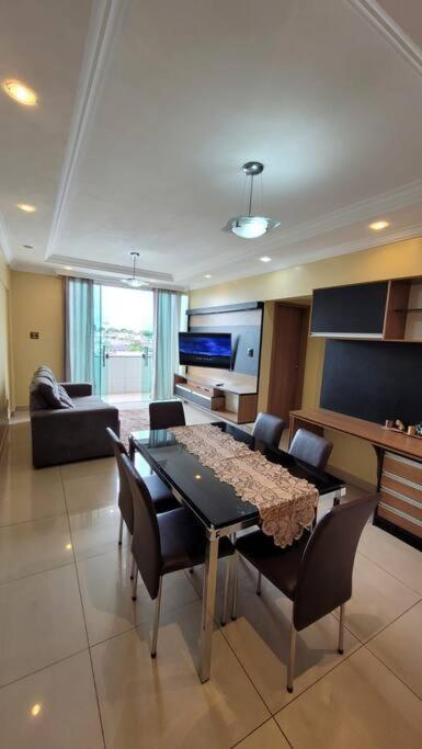 a living room with a dining table and chairs at Apartamento Conforto/Praticidade in Manaus