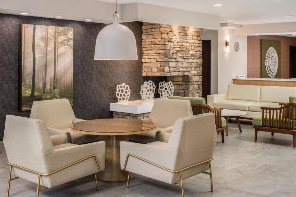 a lobby with chairs and a table and a waiting room at Fairfield Inn & Suites by Marriott Portland Airport in Portland