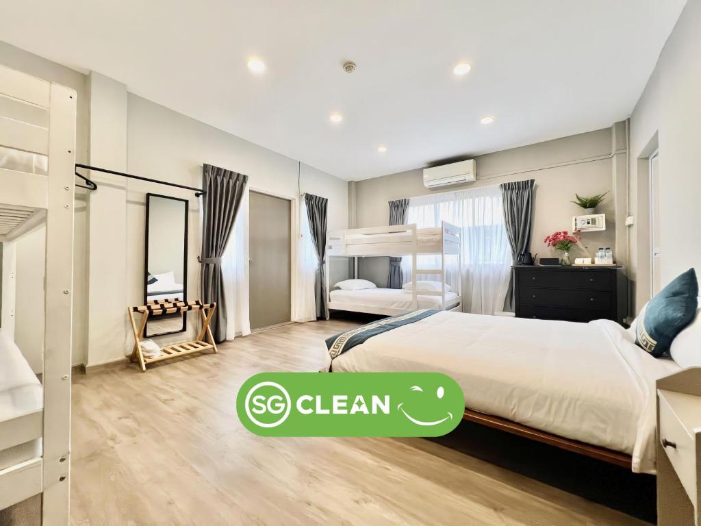 a bedroom with a bed with a sign that says se clean at K2 Guesthouse in Singapore