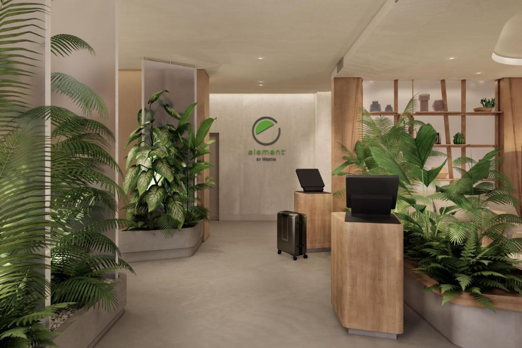 an office with plants in the middle of a lobby at Element Wroclaw in Wrocław