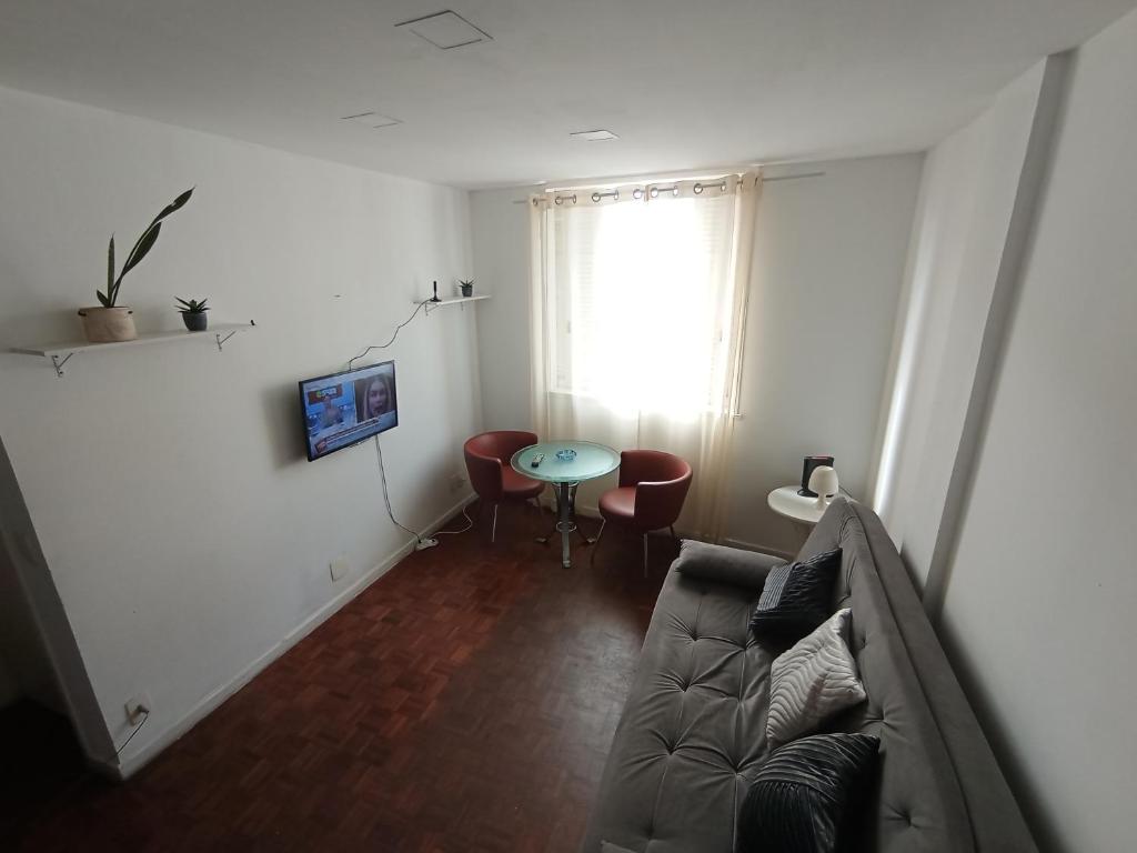 a living room with a couch and a table at Leme in Rio de Janeiro