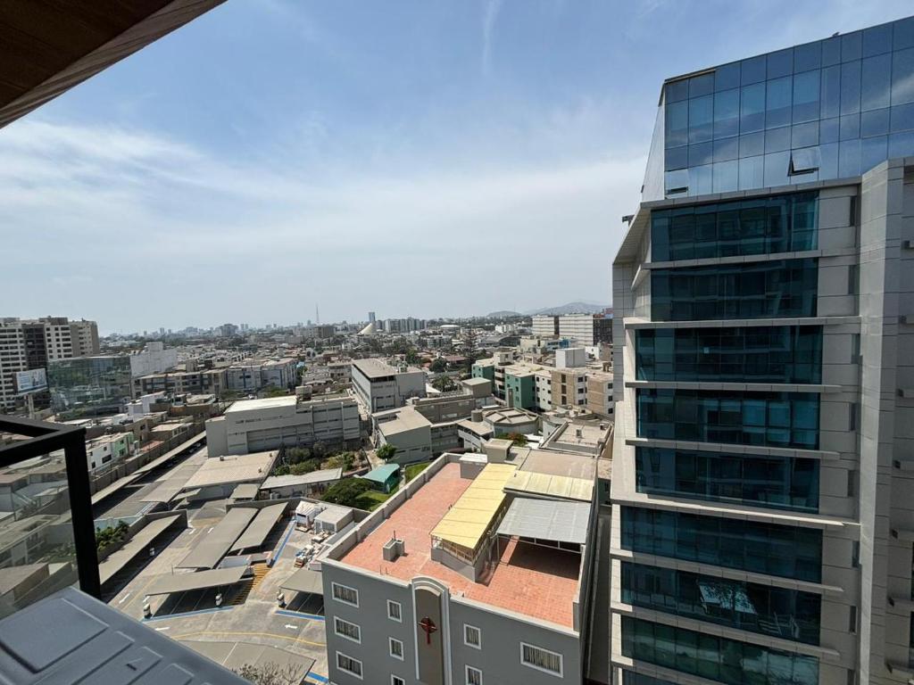 a view of a city with a tall building at LA POSADA de GUILLE - LUXURY APARTS NEXT TO USA EMBASSY in Lima