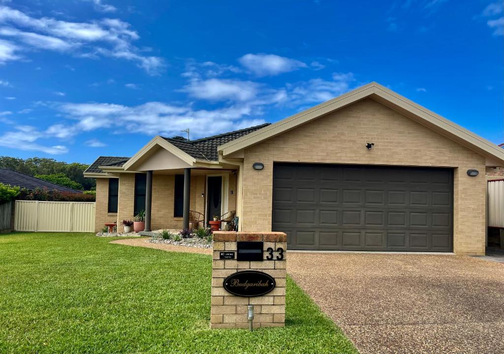 a house with a garage with a driveway at Budgaribah in Old Bar