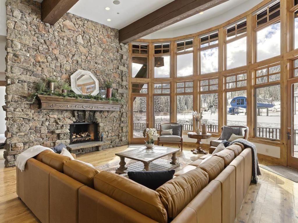 a living room with a couch and a stone wall at Apex Lodge SOL-12011 in Salt Lake City