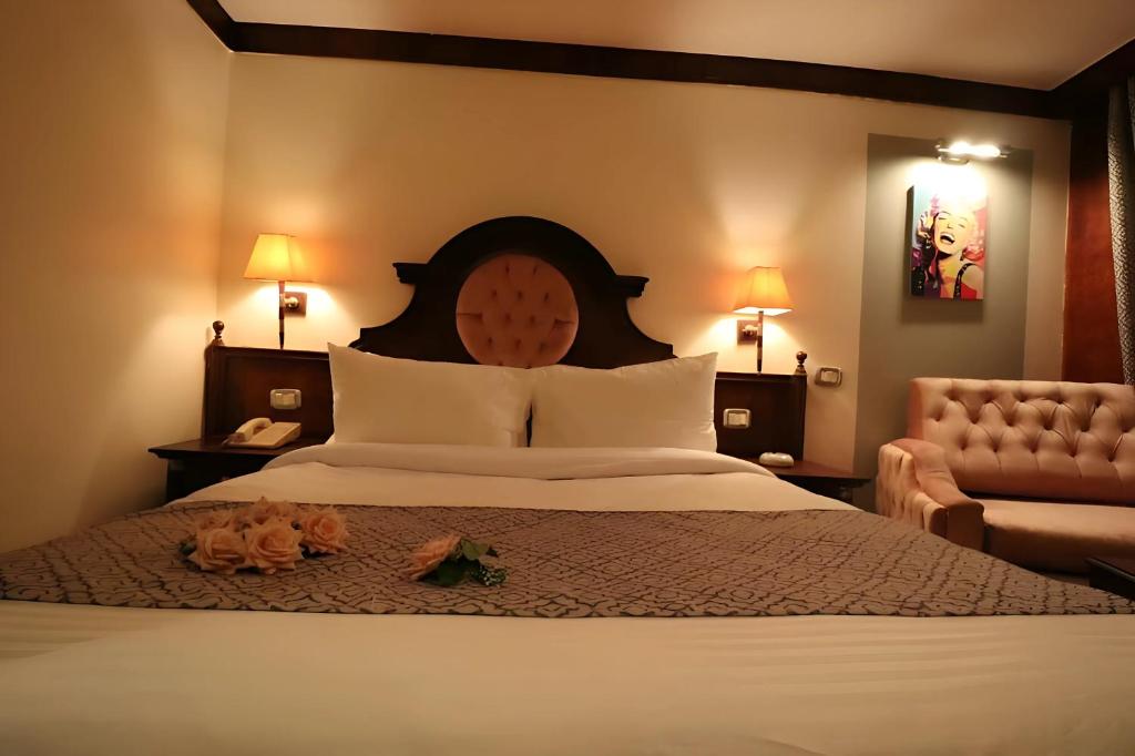 a bedroom with a large bed with a large headboard at Nile CRUISE NPS Every Monday from Luxor 4 nights & every Friday from Aswan 3 nights in Aswan
