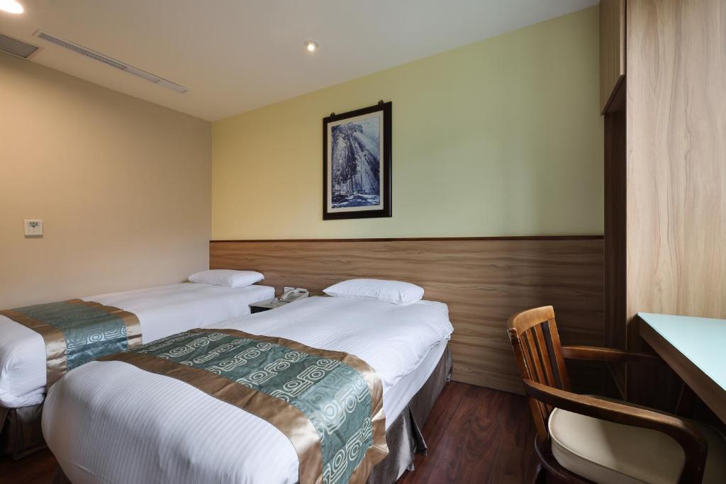 Postel nebo postele na pokoji v ubytování Shante Hotel Shitou