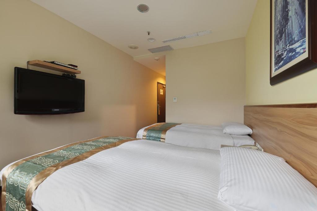 Postel nebo postele na pokoji v ubytování Shante Hotel Shitou