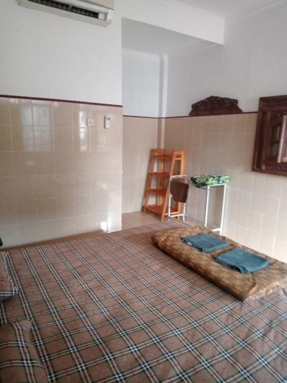 Postel nebo postele na pokoji v ubytování Cempaka 2 Homestay