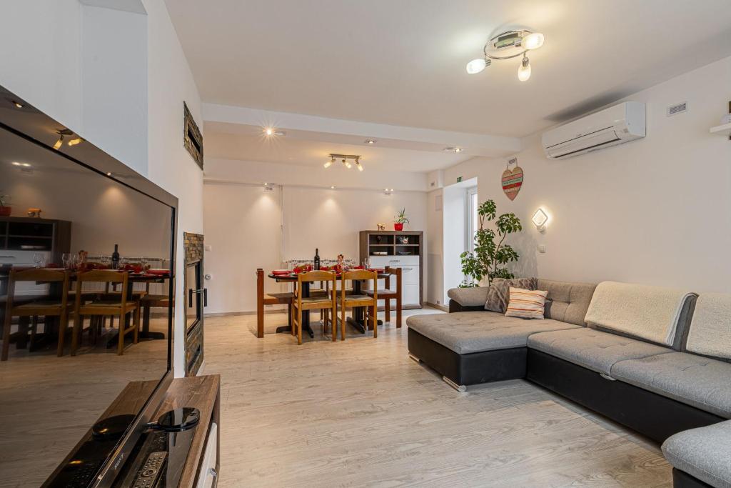 a living room with a couch and a table at House Dijana With Pool - Happy Rentals in Nova Vas