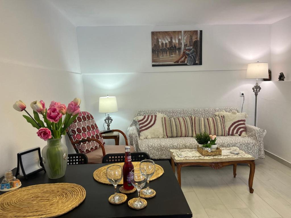 a living room with a couch and a table at Pigadia Central in Karpathos Town