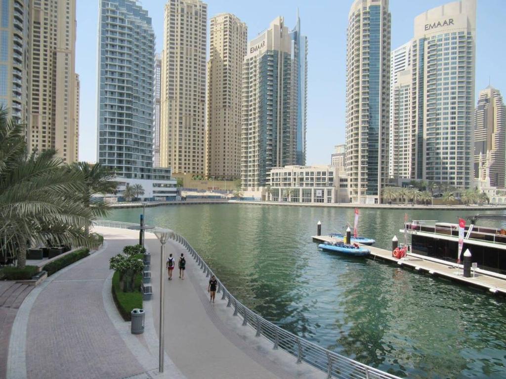 a river in a large city with tall buildings at Frank Porter - Marina Views Tower in Dubai