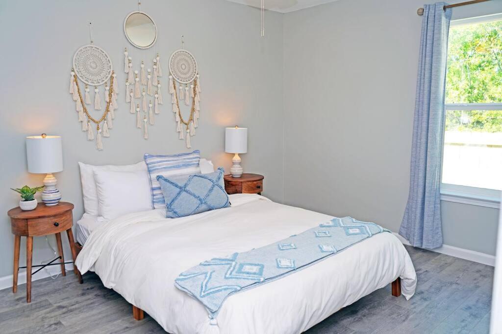 a white bedroom with a bed and a window at The Blue Pearl 6min to Downtown -Short Beach Drive in Pensacola