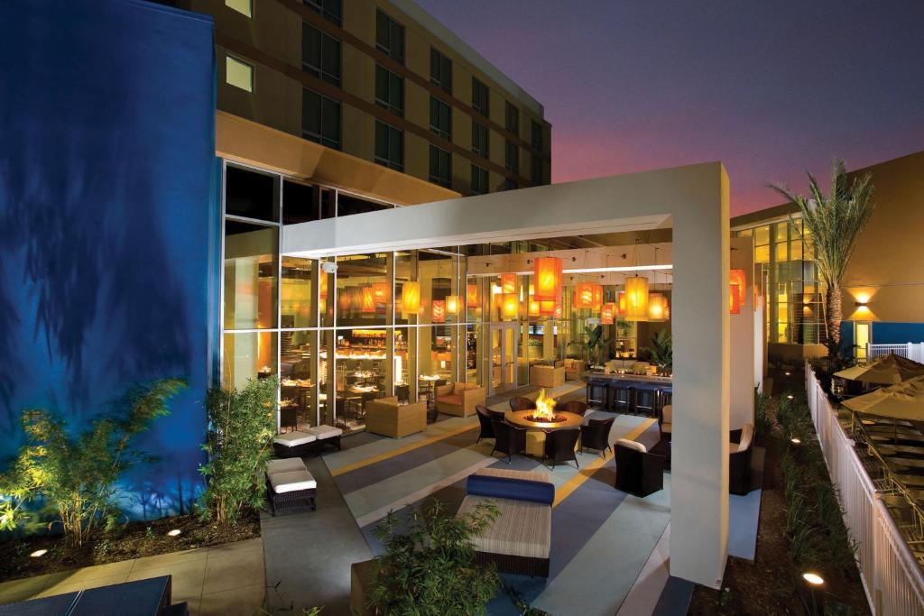 - un bâtiment avec une terrasse dotée de tables et de chaises dans l'établissement Renaissance ClubSport Aliso Viejo Laguna Beach Hotel, à Aliso Viejo