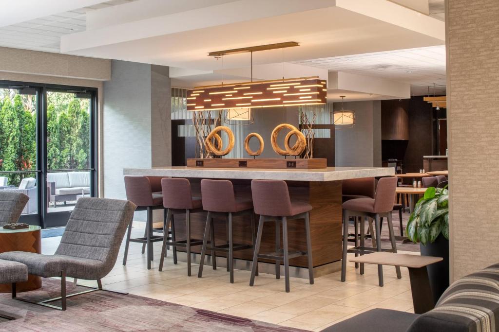 a kitchen with a large island with bar stools at Courtyard by Marriott Portland Airport in Portland