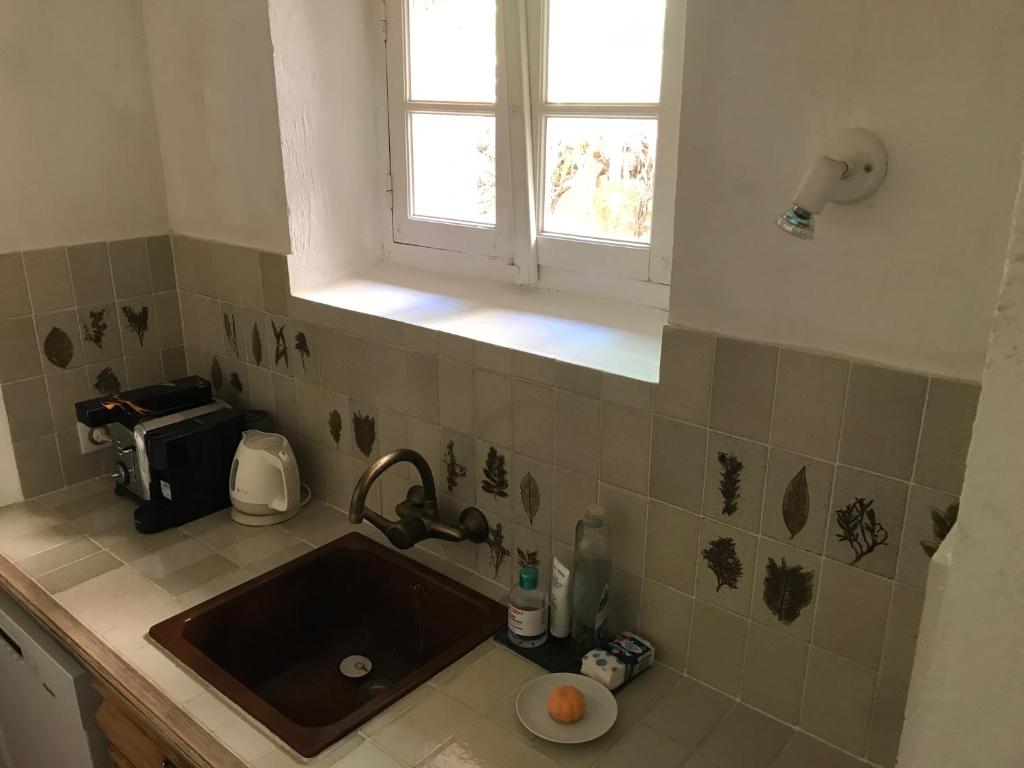 a kitchen counter with a sink and a window at ST FRANCOIS in Grasse