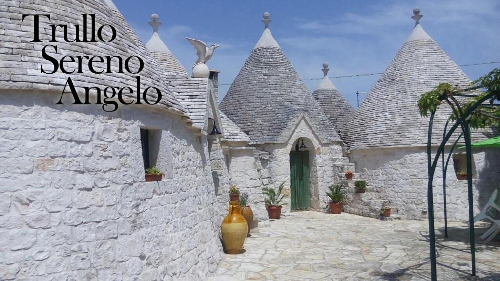 a white building with a building with turrets at Trullo Sereno Angelo in Locorotondo