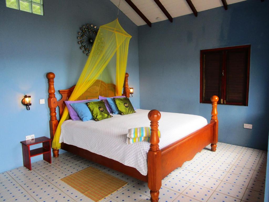 a bedroom with a bed with a canopy at The Sweet Retreat in Port Elizabeth