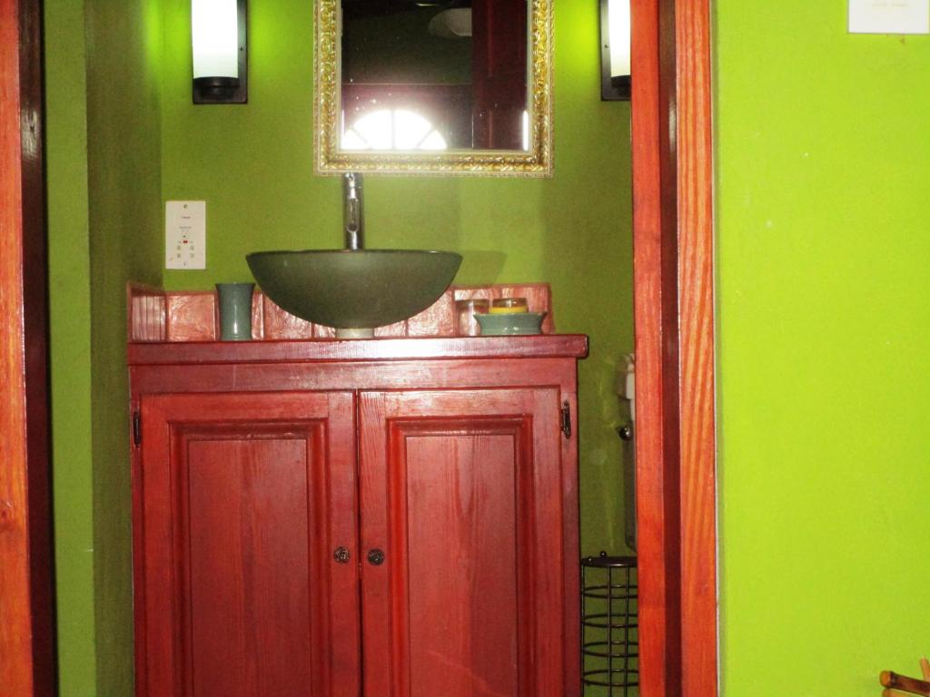 a bathroom with a sink on top of a red cabinet at The Sweet Retreat in Port Elizabeth