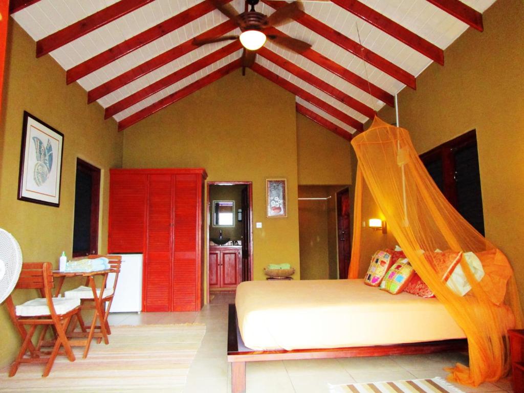 a bedroom with a bed with a red and white ceiling at The Sweet Retreat in Port Elizabeth