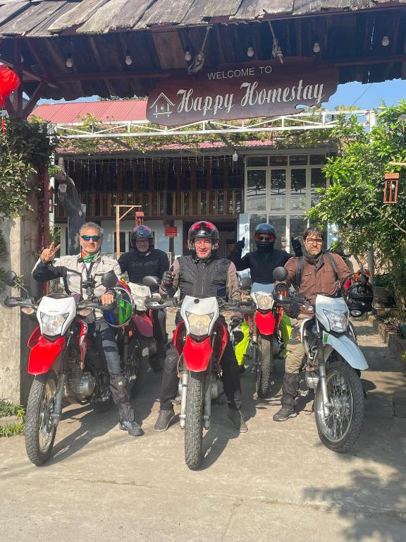 a group of people on motorcycles parked in front of a building at Hà Trang Homestay in Nghĩa Lộ