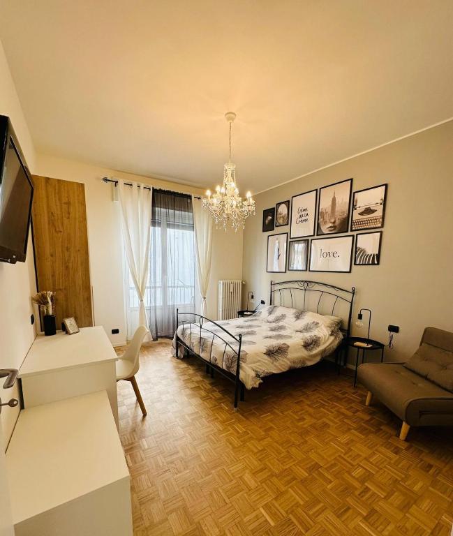 a bedroom with a bed and a living room at D-Living Casa Vigevano in Vigevano
