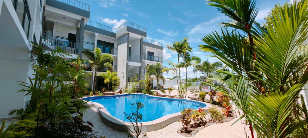 a resort with a swimming pool in front of a building at Ocean Breeze Apartment in Nadi